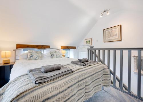 a bedroom with a large bed with two pillows on it at 1 Bed in Ashover oc-dclhil in Ashover