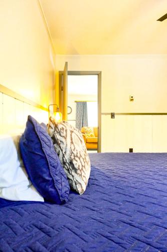 a bedroom with a bed with two pillows on it at Charming Ski Chalet at Powderhorn Mountain in Bessemer