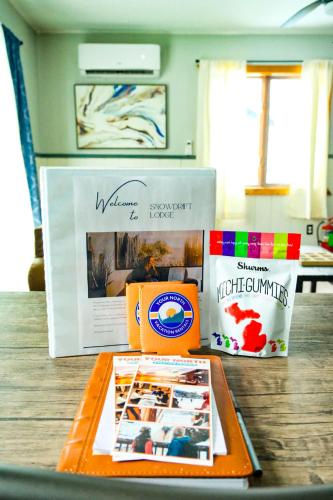 a table with a box of food and a book at Charming Ski Chalet at Powderhorn Mountain in Bessemer