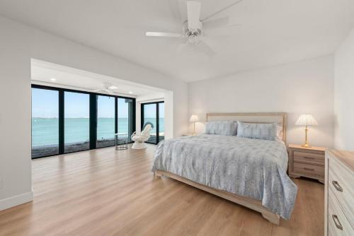 a bedroom with a bed and a view of the ocean at Mariner Pointe 941 in Sanibel