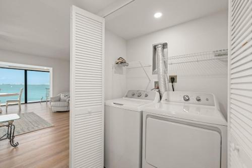 a white laundry room with a washer and dryer at Mariner Pointe 941 in Sanibel