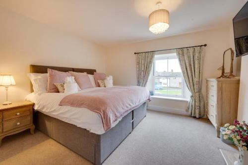 a bedroom with a large bed and a window at 1 Bed in Crakehall oc-ds955 in Crakehall
