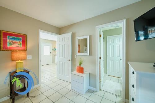 a living room with white doors and a tv at Sandcastle Up in Myrtle Beach