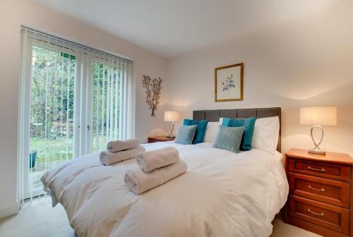 a bedroom with a large white bed with towels on it at 1 Bed in Belford oc-nb677 in Belford