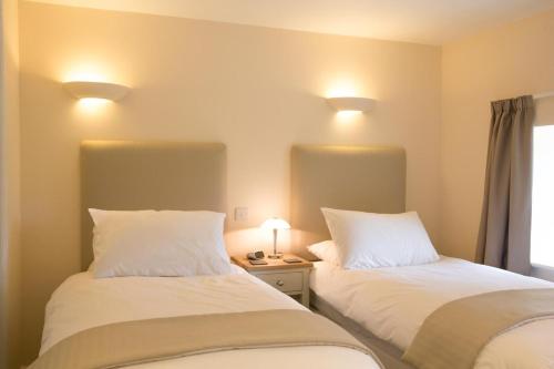 two beds sitting next to each other in a room at 3 Bed in Low Row oc-ds1030 in Gunnerside