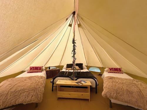 a room with three beds in a tent at Dovedale in Ashbourne