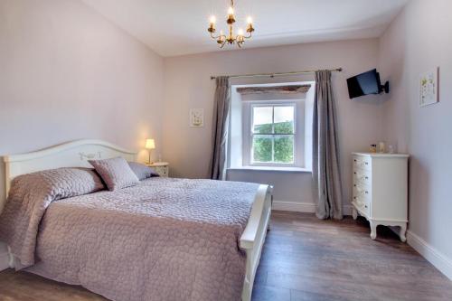 a bedroom with a bed and a window and a dresser at 2 Bed in Low Row oc-ds059 in Feetham