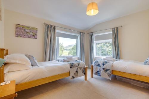 a bedroom with two beds and a window at 2 Bed in Hawes oc-ds052 in Hawes