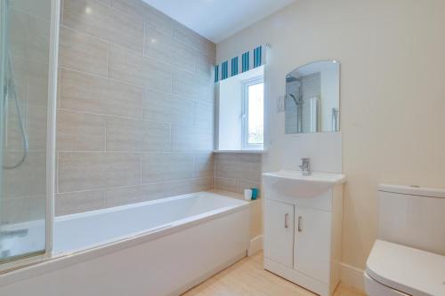a white bathroom with a tub and a sink at 2 Bed in Hawes oc-ds052 in Hawes