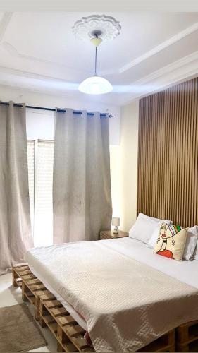 a bedroom with a large bed in front of a window at Appartement Bissau in Dakar