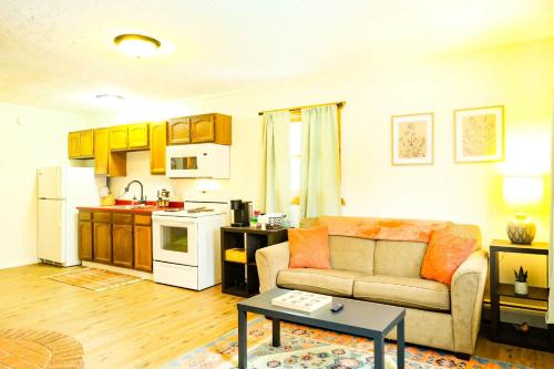 a living room with a couch and a kitchen at Snowbound Bliss at Powderhorn Mountain in Bessemer