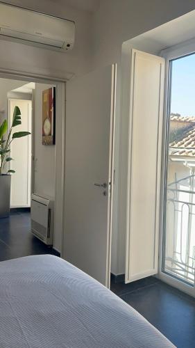 a bedroom with a bed and a large window at Maison Grimoaldo10 in Salerno