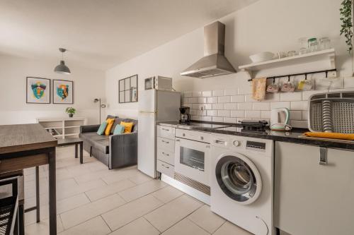 a kitchen with a washer and dryer in it at The Energy Apartment in Caleta De Fuste