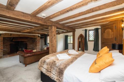 a bedroom with a large bed and a fireplace at Gildridge in Lewes
