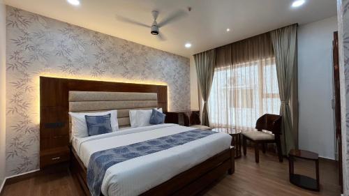 a bedroom with a large bed in a room at Hotel Sudha Brahma in Tirupati