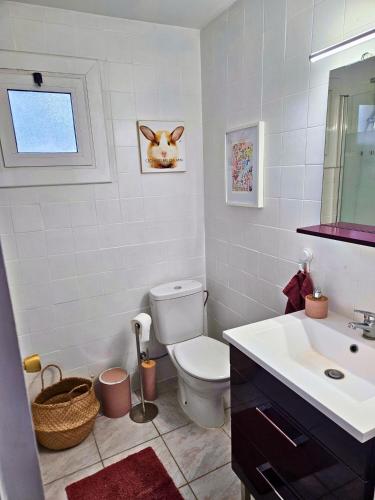 a bathroom with a toilet and a sink at Digital Nomad Apartment in L'Escala