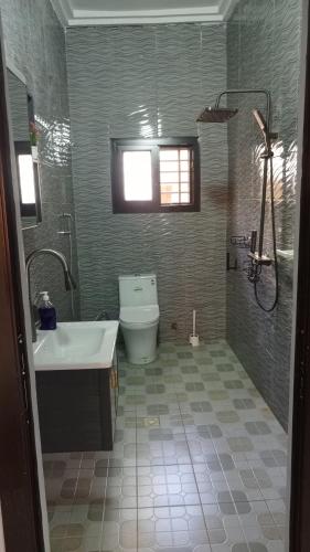 a bathroom with a tub and a toilet and a sink at LEYLA house Résidence haut Standing in Bamako