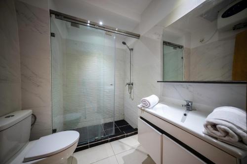 a bathroom with a shower and a toilet and a sink at Apartment in Adan Beach Residence With Pool in Aourir
