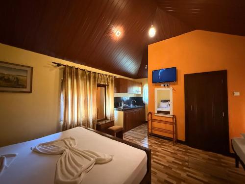 a hotel room with a bed and a kitchen at Crown Holiday Village near Marawila in Nattandiya
