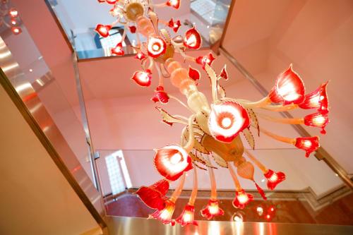 a vase filled with red and white christmas lights at Boutique Hotel Piazza Grande Locarno - Easy Self Check-In in Locarno