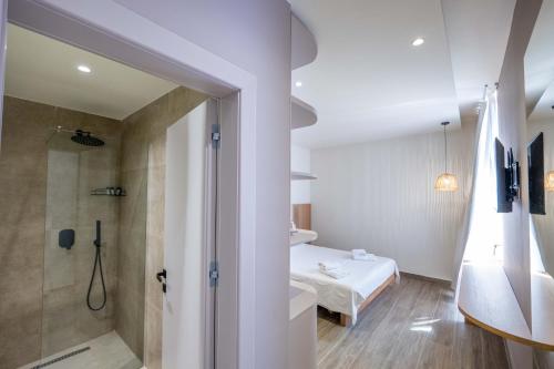 a small bathroom with a bed and a shower at Mirage Bay Deluxe in Sarandë