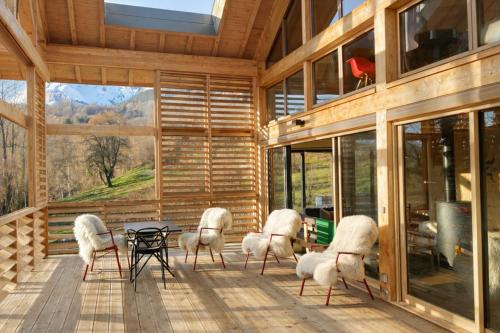 a group of chairs sitting on a porch with a table at Chalet ToutBlanc in Servoz