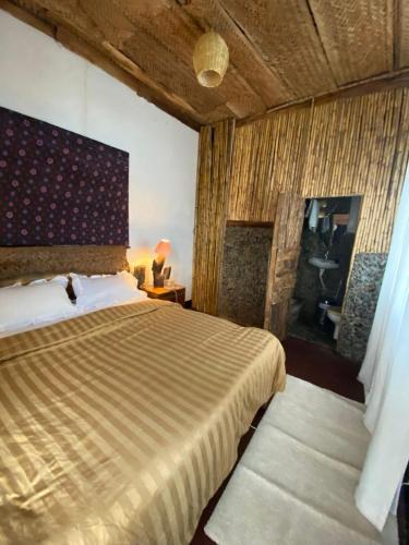 a bedroom with a large bed in a room at Nguruma house of travellers and tours in Arusha