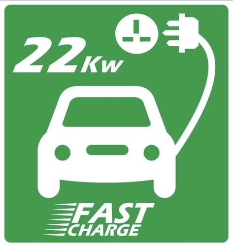 a sign with a car plugged into a fast charger at The Hive Apartment in Stockport