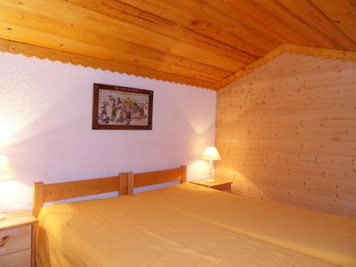 a bedroom with a bed in a wooden room at Scenic Apartment near Ski Area in Meribel in Méribel