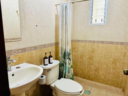 a bathroom with a toilet and a sink at Casita Iluminada in Oaxaca City