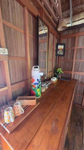 a room with a wooden table in a cabin at Yonas Homestay - Raja Ampat in Besir
