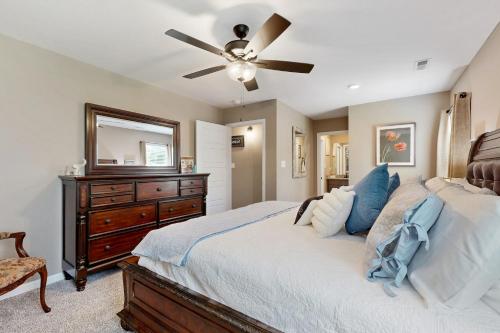 a bedroom with a bed with a ceiling fan and a dresser at Gateway to Fort Campbell! Home w/ Furnished Deck in Clarksville