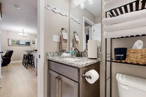 a bathroom with a sink and a vanity with a mirror at Gateway to Fort Campbell! Home w/ Furnished Deck in Clarksville