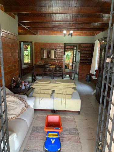 a living room with several beds and a table at Chalé Gravatá 2022 in Gravatá