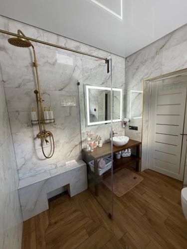 a bathroom with a shower and a sink at Luxury Home in Slavske