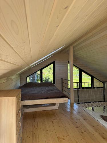 a bed in the middle of a room with windows at Luxury Home in Slavske