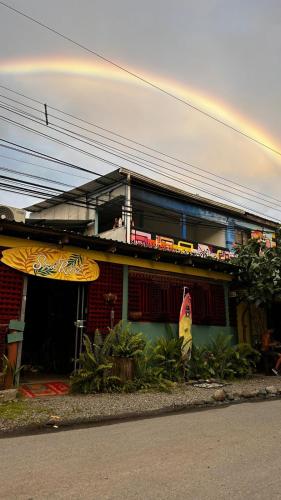 a building with a surfboard on top of it at Soul Rebel Hostel in Puerto Viejo
