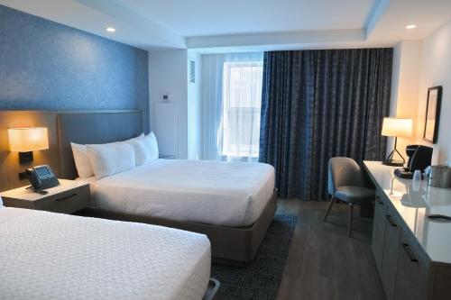 a hotel room with two beds and a desk at Miccosukee Casino & Resort in Miami