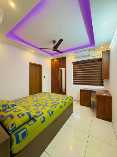 a bedroom with a bed and a purple ceiling at Haven by Glass Loft-Premium 2BHK near KIMS and GG Hospital in Trivandrum