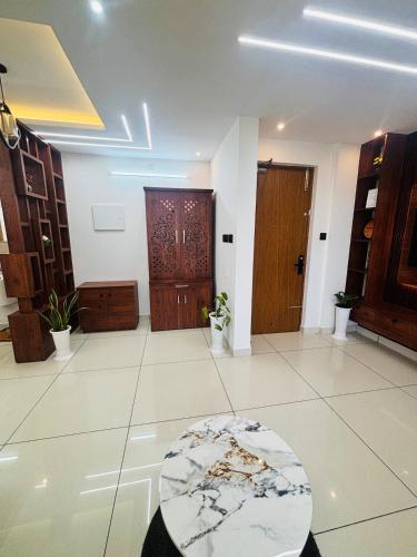 a large room with a table in the middle of it at Haven by Glass Loft-Premium 2BHK near KIMS and GG Hospital in Trivandrum