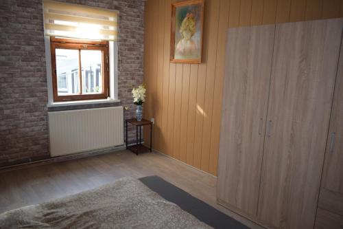 a room with a large wooden cabinet and a window at Ferienwohnug Home in Gotha