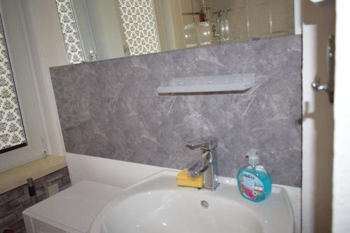 a bathroom sink with a bottle of soap on it at Ferienwohnug Home in Gotha