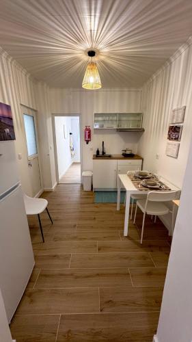 a kitchen with a table and a kitchen with a counter at Raiz Atlântica in Angra do Heroísmo