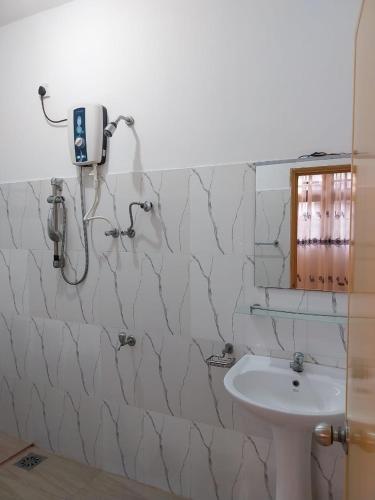 a bathroom with a sink and a shower at Villa Anu in Hikkaduwa