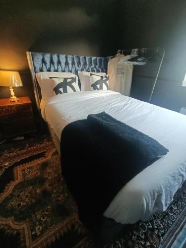 a bedroom with a bed with a black pillow on it at Room FULHAM TF2 in London