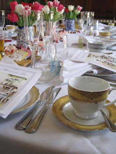 a table with a cup and plates and silverware at The Culver Hotel in Los Angeles