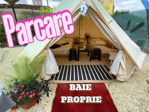 a tent with a table and a sign that readsapaediaediaediaarma at Aurora Glamping in Vama Veche