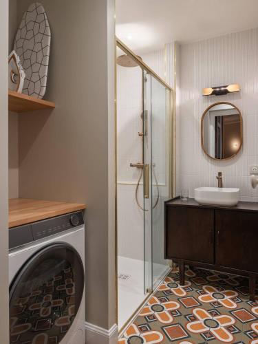 a bathroom with a shower and a washing machine at Le Dubedout - Hyper Centre - Bastille in Grenoble