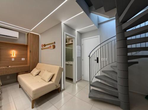 a living room with a staircase and a couch at Maré Alta Beach Hall by AFT in Tamandaré