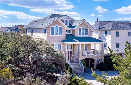 a large house on the beach with trees at Crow's Nest - Corolla, Crown Point, 150 Yds to Beach, Hot Tub, Community Pool, Pets OK in Corolla